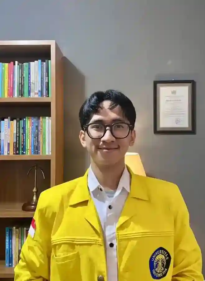 Profile portrait in a yellow university jacket.